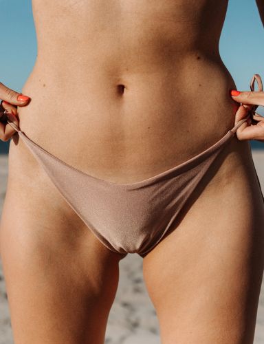 woman holding her bikini - labiaplasty
