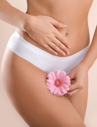woman with white underwear holding a flower - labiaplasty